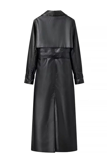 Black - A woman walking down a city street wearing a deep burgundy maxi-length trench coat in a smooth leather-look material, styled with a black turtleneck, black stirrup pants, and black heels.