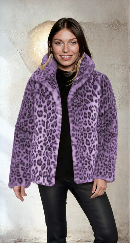 Purple - A woman wearing a cropped leopard print faux fur jacket with a structured collar, styled over a black turtleneck and black leather pants.
