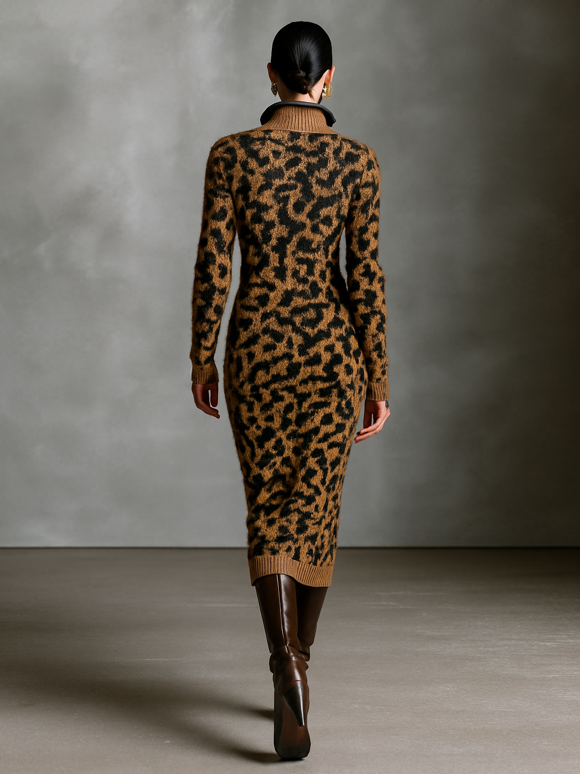 Brown - A model wearing a long-sleeve leopard print knit midi dress with a half zip funnel neck, styled with brown leather knee-high boots against a textured grey background.