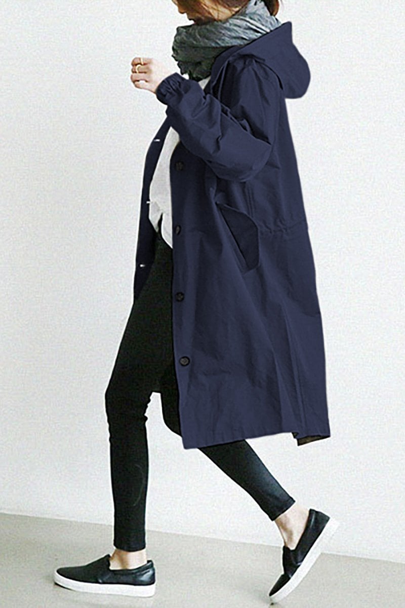 Navy Blue - A model wearing a light grey mid-length hooded coat with a single-breasted button front, styled with a black scarf and black pants against a plain white background.