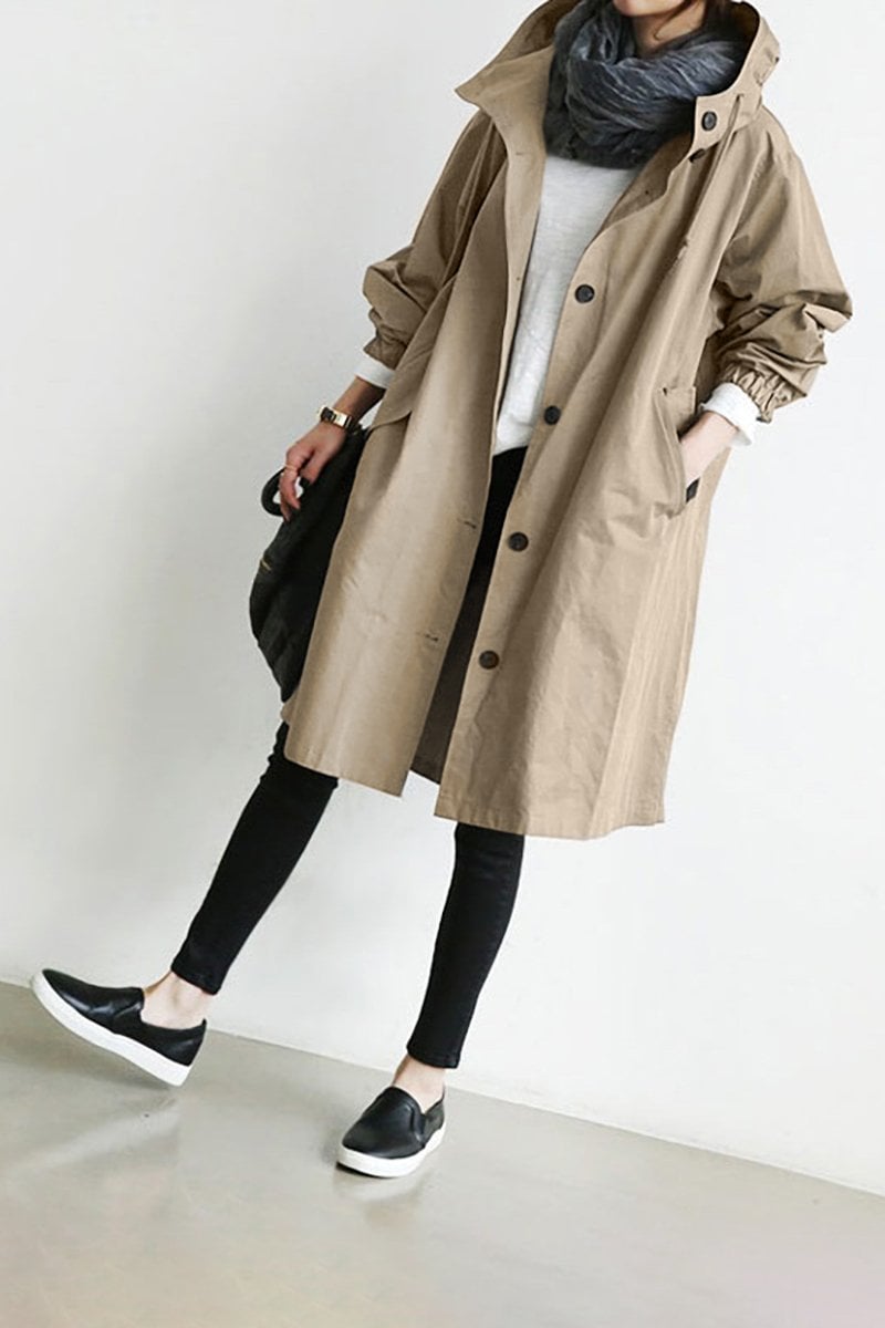 Beige - A model wearing a light grey mid-length hooded coat with a single-breasted button front, styled with a black scarf and black pants against a plain white background.