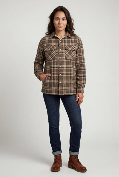 Khaki - A woman wearing a brown plaid check shirt jacket with a cream-coloured sherpa lining, styled with dark blue slim-fit jeans and brown leather lace-up boots against a plain grey background.