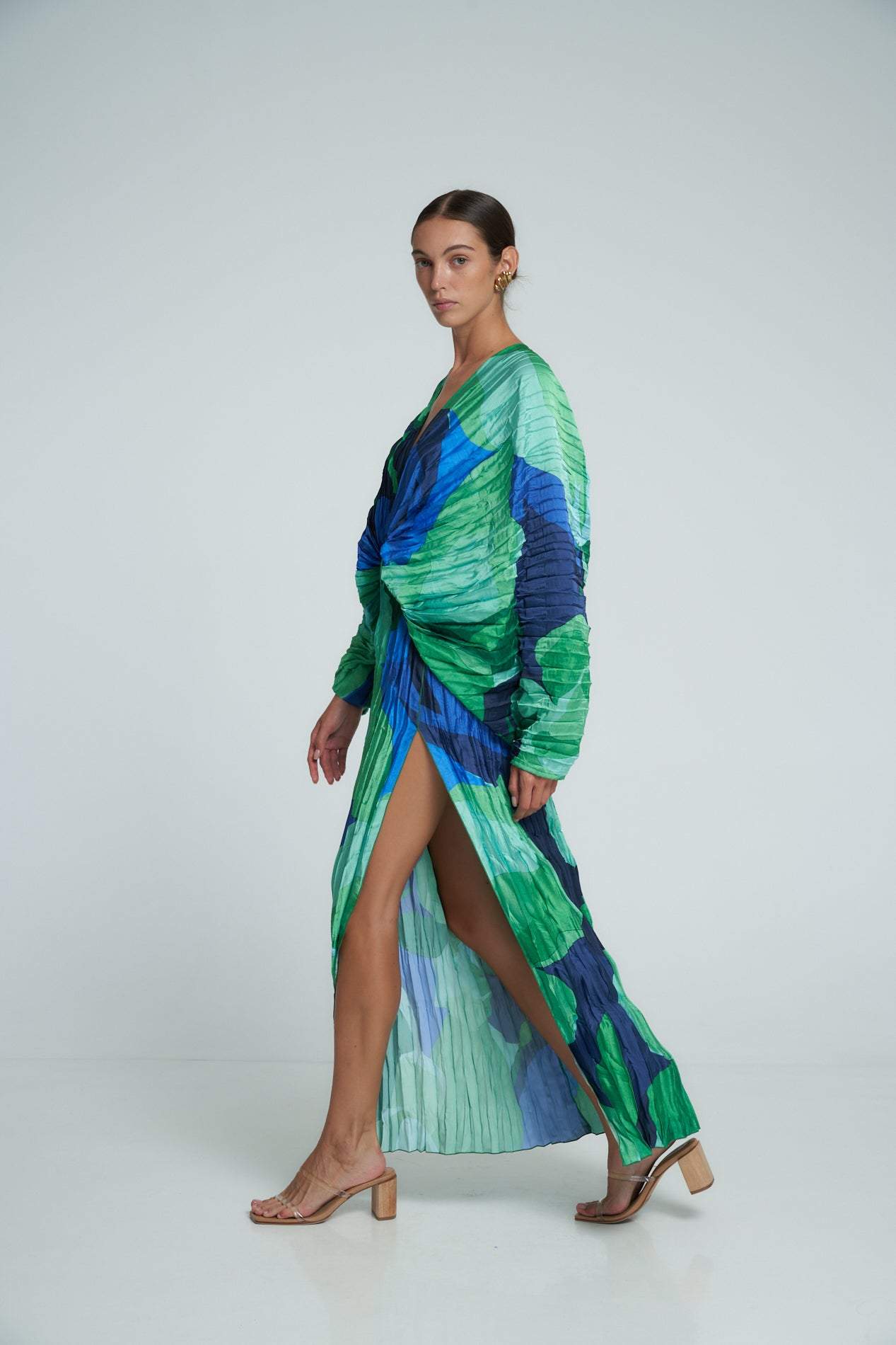Green - Women's formal maxi dress featuring an all-over micro-pleated texture, bold green and blue abstract print, deep V-neckline, voluminous long sleeves, and a high side slit.