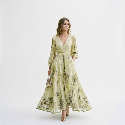 Yellow - A woman wearing a pale green long-sleeve maxi dress with a dark green floral motif, featuring a pleated chiffon texture, V-neckline, and a flowing skirt.