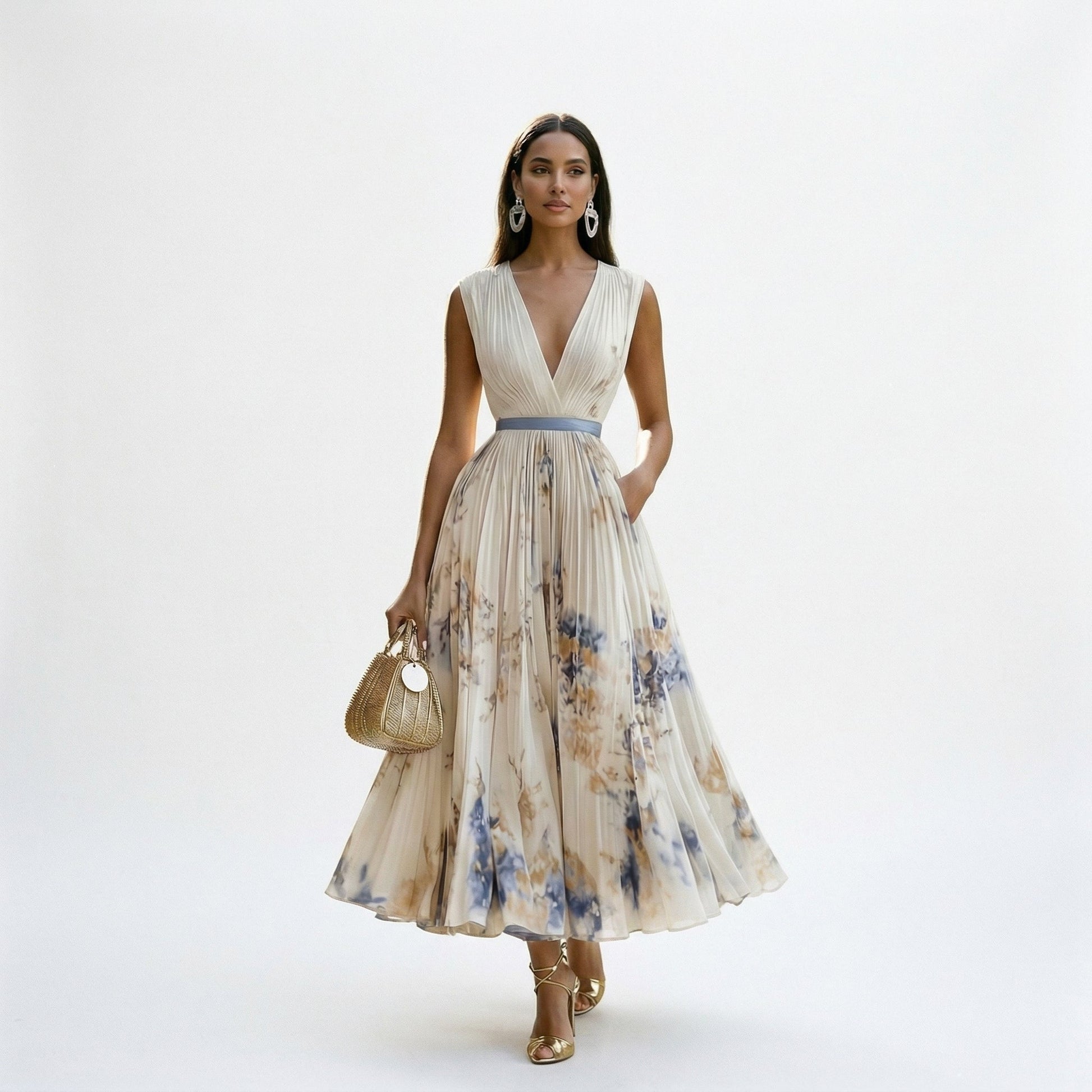 White - A woman wearing a pale green long-sleeve maxi dress with a dark green floral motif, featuring a pleated chiffon texture, V-neckline, and a flowing skirt.