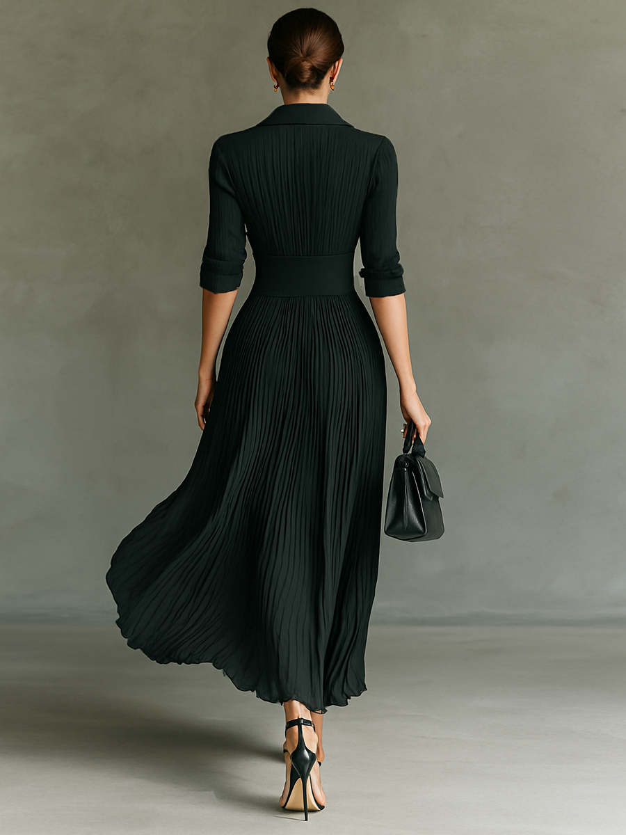 Black - A woman wearing a sophisticated black pleated maxi dress with a structured corset waistband, gold buttons, a spread collar, and elbow-length sleeves.