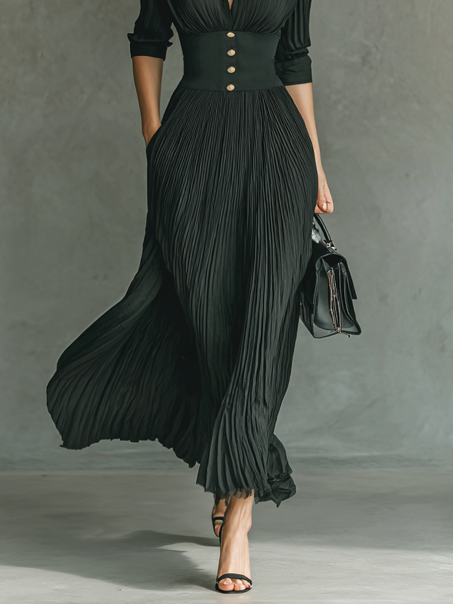 Black - A woman wearing a sophisticated black pleated maxi dress with a structured corset waistband, gold buttons, a spread collar, and elbow-length sleeves.