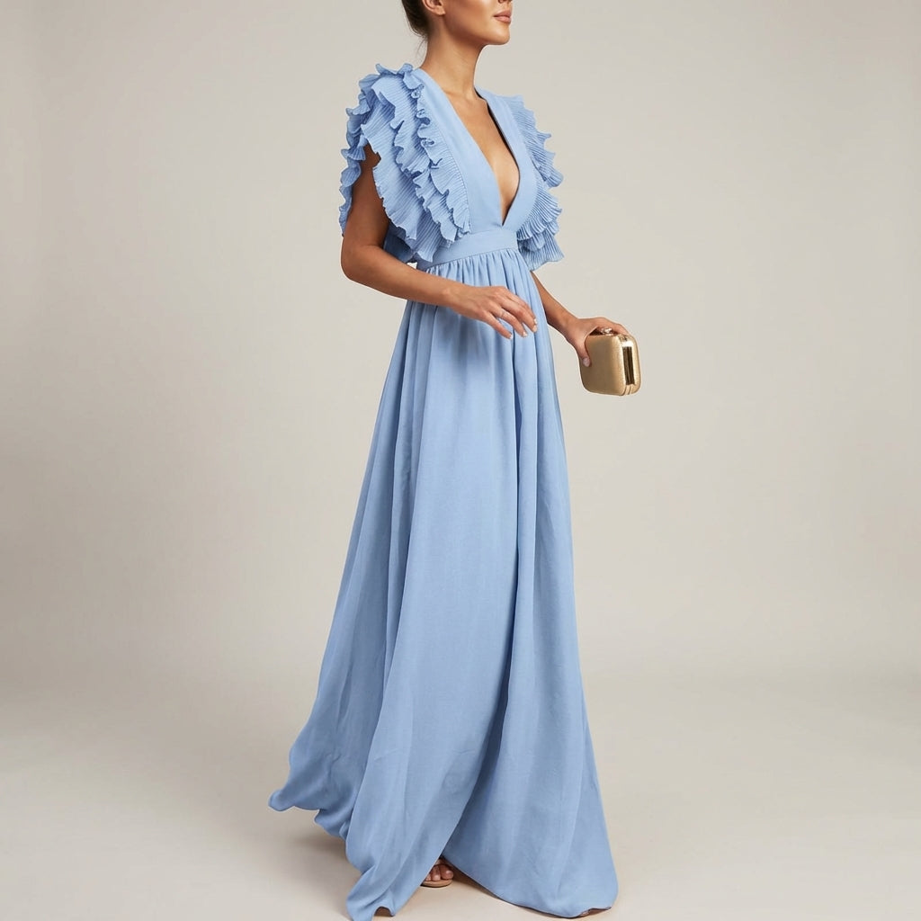 Blue - A woman wearing a floor-length cornflower blue maxi dress with a plunging V-neckline and voluminous, finely pleated ruffle sleeves, holding a gold clutch.