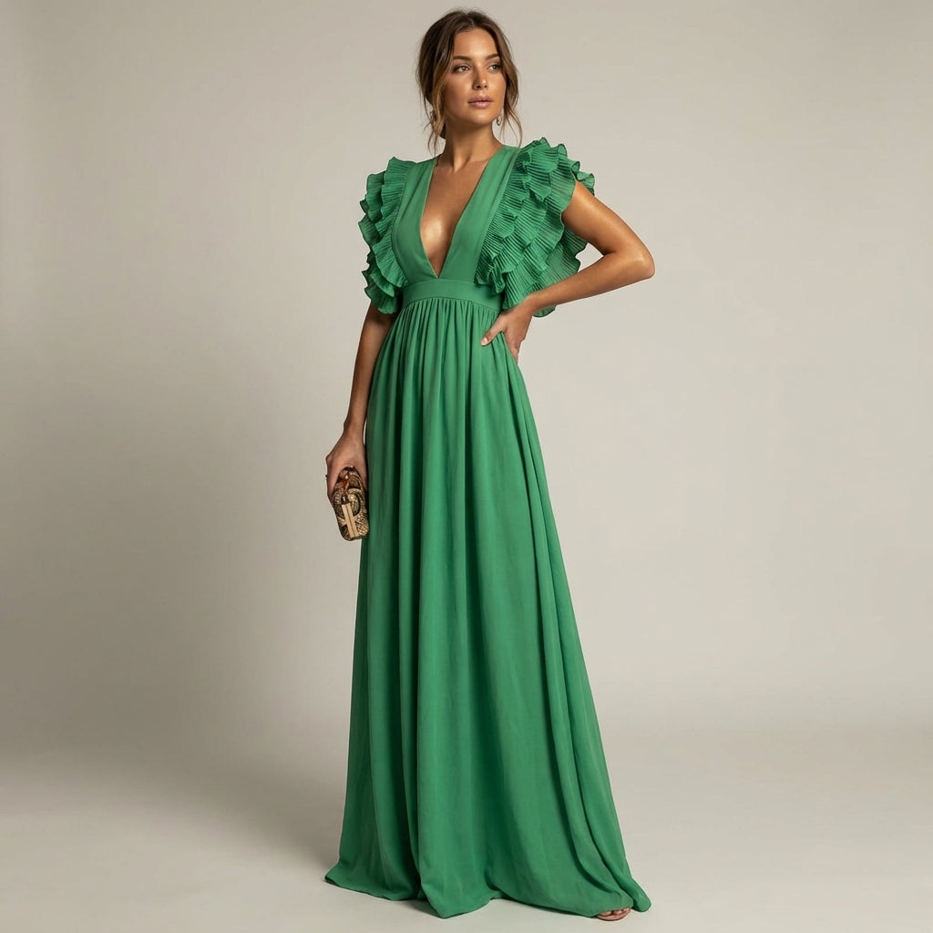 Green - A woman wearing a floor-length cornflower blue maxi dress with a plunging V-neckline and voluminous, finely pleated ruffle sleeves, holding a gold clutch.