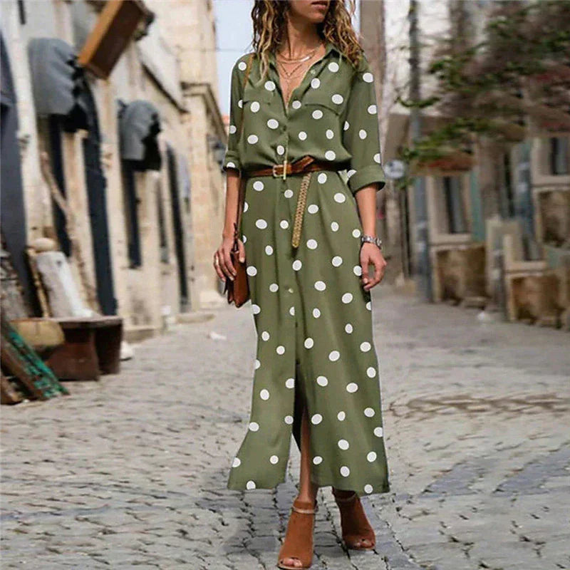 Army Green - Woman walking outdoors wearing a long polka dot button-front shirt dress with long sleeves and chest pockets