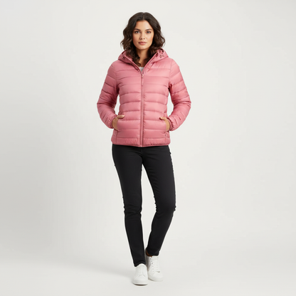Light Pink - A woman wearing an off-white hooded puffer jacket with horizontal quilting, zipped up, paired with blue jeans against a plain white background.