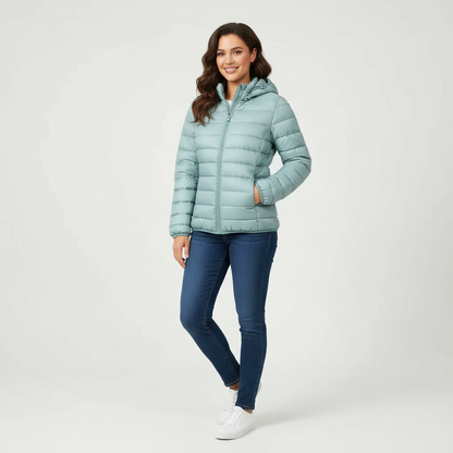 Light Blue - A woman wearing an off-white hooded puffer jacket with horizontal quilting, zipped up, paired with blue jeans against a plain white background.