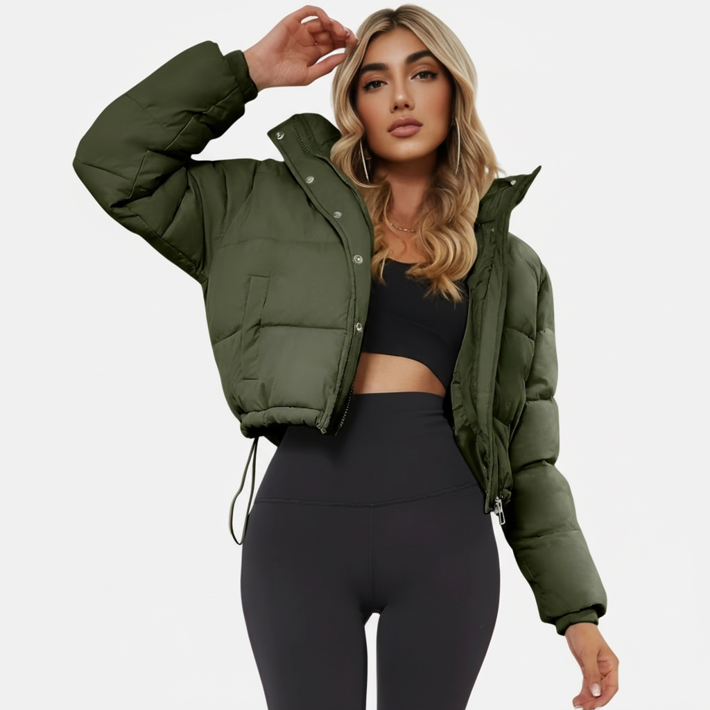 Army Green - A woman wearing a dark brown cropped puffer jacket with an integrated hood, featuring horizontal quilting, a front zip closure, and adjustable drawstring toggles at the hem, paired with black high-waisted jeans.