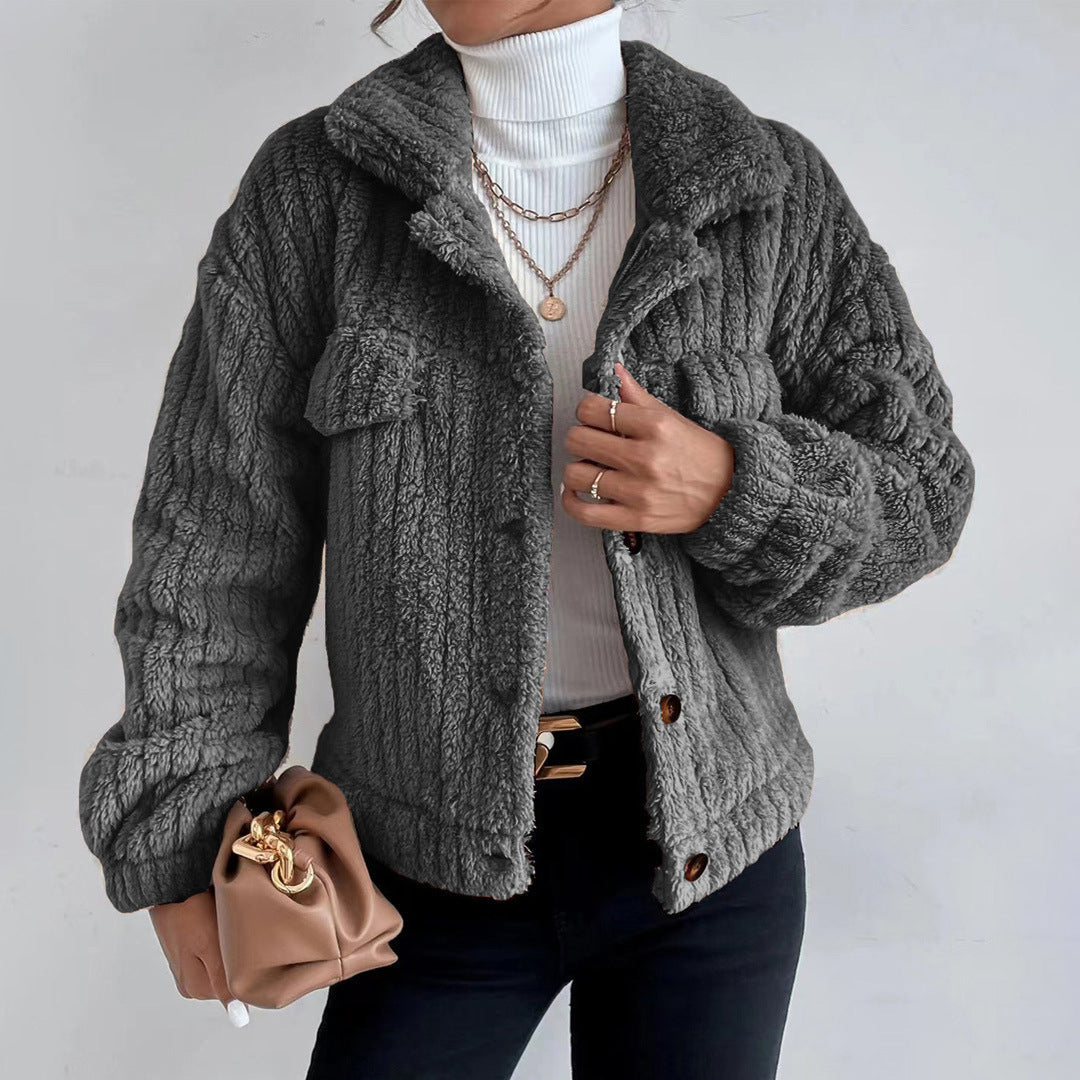 Dark Gray - Women's black heavyweight faux shearling jacket featuring a collared neckline, tortoiseshell buttons, dual chest pockets, and a distinct vertical ribbed texture, styled over a white turtleneck.