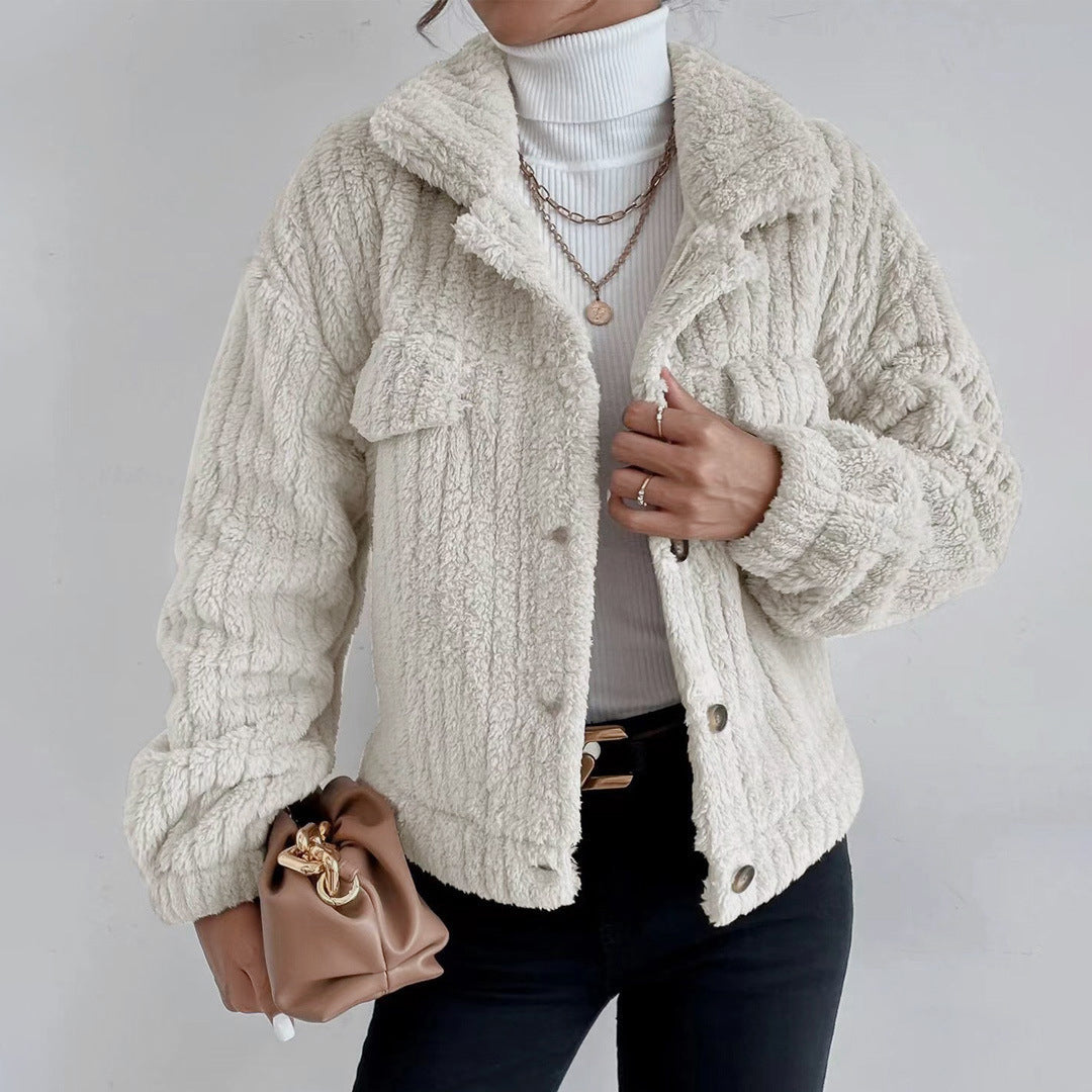 White - Women's black heavyweight faux shearling jacket featuring a collared neckline, tortoiseshell buttons, dual chest pockets, and a distinct vertical ribbed texture, styled over a white turtleneck.