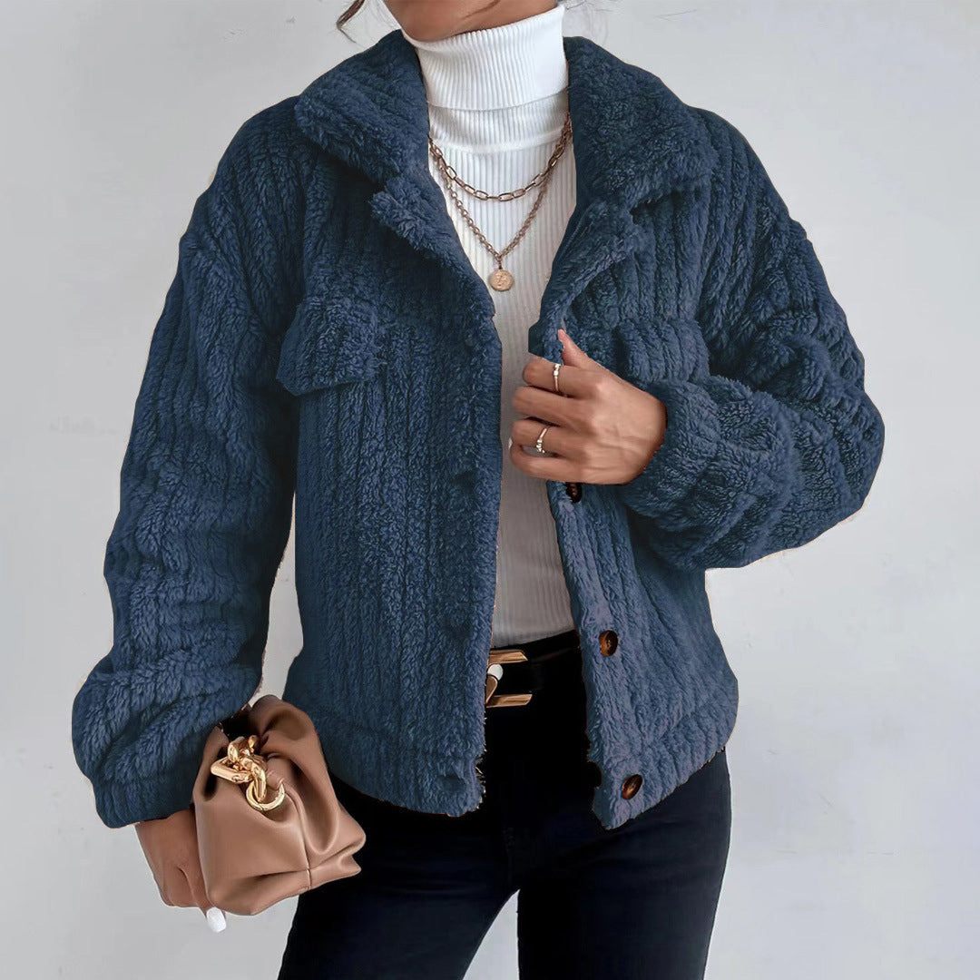 Dark Blue - Women's black heavyweight faux shearling jacket featuring a collared neckline, tortoiseshell buttons, dual chest pockets, and a distinct vertical ribbed texture, styled over a white turtleneck.