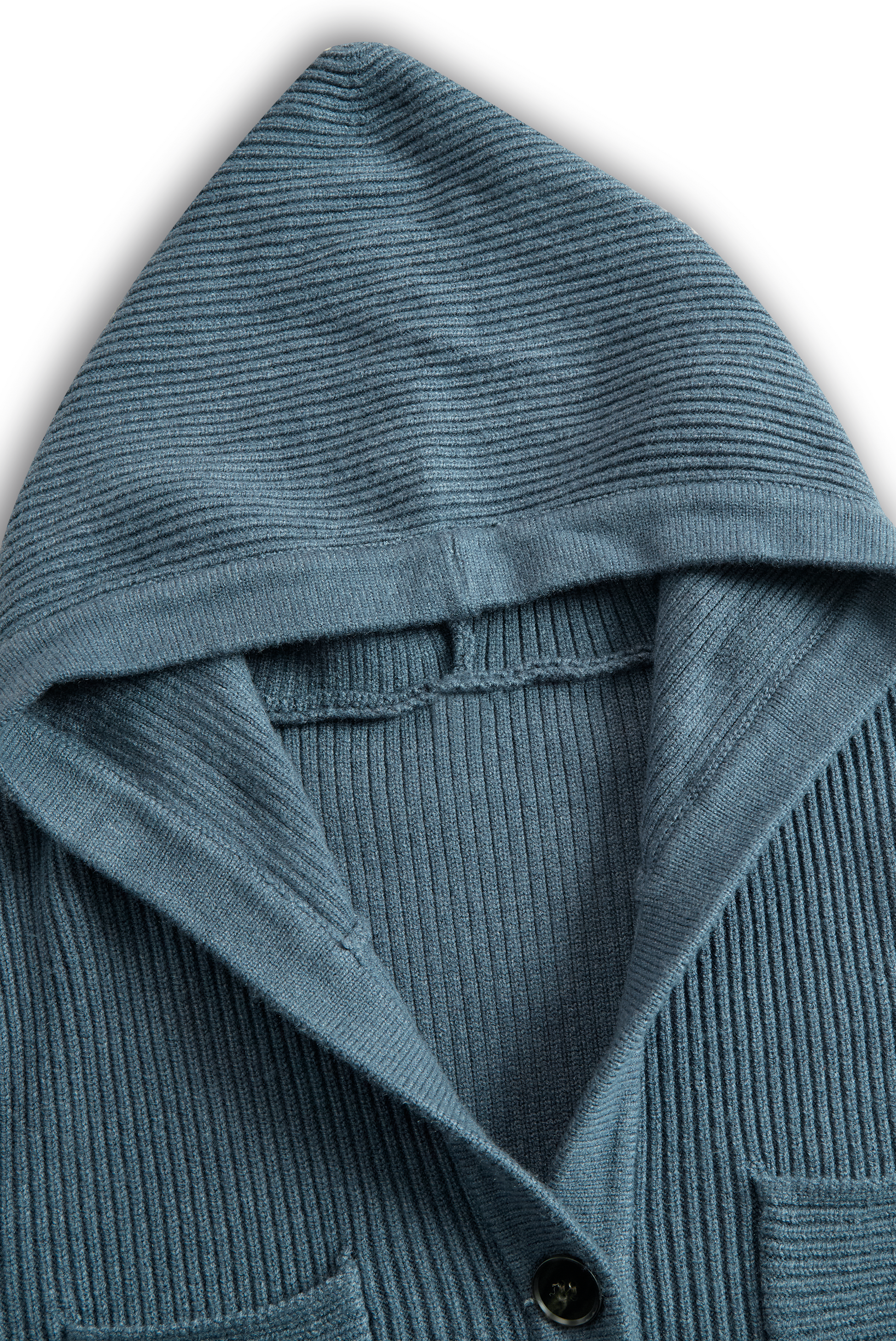 Green - A woman wearing a long-sleeve, blue-grey ribbed knit maxi dress featuring a hood, a button-down neckline, and chest flap pockets, paired with a woven tote bag.