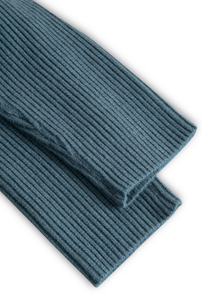 Green - A woman wearing a long-sleeve, blue-grey ribbed knit maxi dress featuring a hood, a button-down neckline, and chest flap pockets, paired with a woven tote bag.
