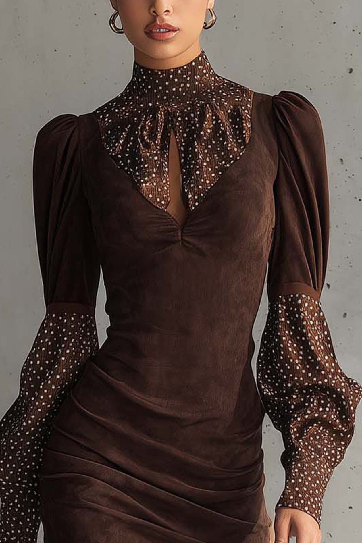 Brown - Woman wearing a fitted ruched mini dress featuring a solid bodice and sheer dotted high neckline and long puff sleeves