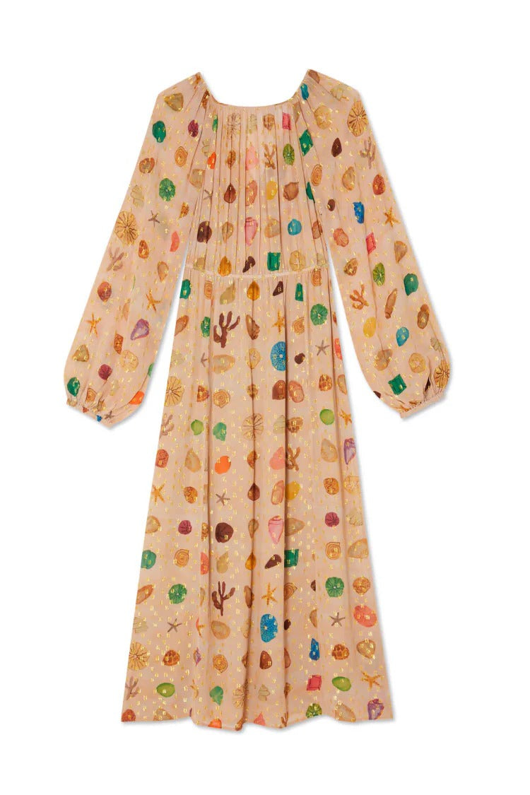 Multicolor - A woman leans against a textured stone wall wearing a peach-coloured maxi dress featuring a multi-coloured seashell motif, gold Lurex flecks, a plunging V-neckline, and long billowy sleeves.