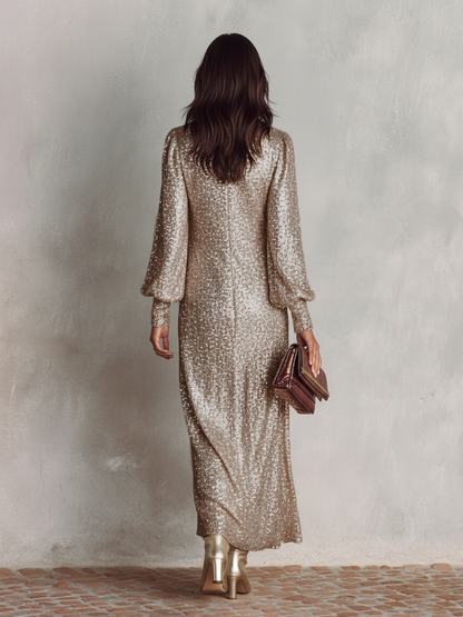 Black - A woman wearing a long-sleeved, champagne-gold sequined maxi dress with a split V-neckline and cuffed sleeves, holding a metallic clutch and a glass of red wine.