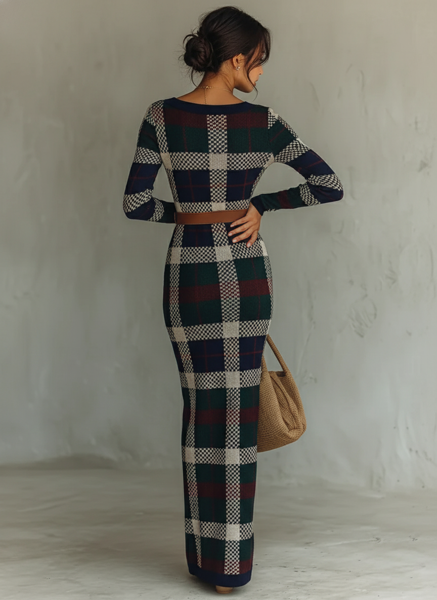 Navy - A woman wearing a long-sleeve, square-neck maxi knit dress featuring a classic navy, green, and white plaid pattern, styled with a brown leather belt at the waist.