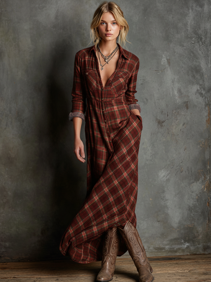 Red - A woman wearing a green and brown tartan plaid maxi shirt dress with a button-down front, long sleeves rolled up, and chest pockets, paired with brown leather cowboy boots against a textured grey wall.