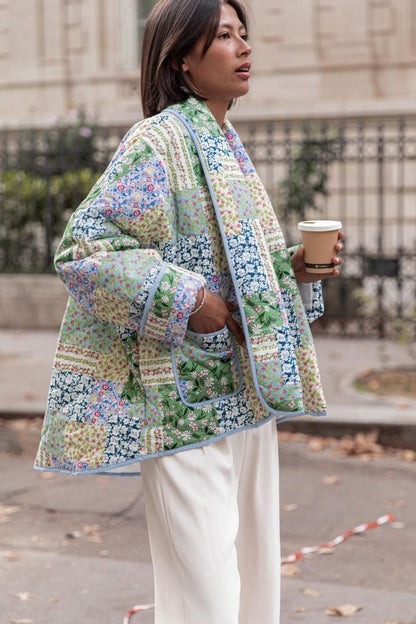 Multicolor - Women's relaxed-fit quilted jacket featuring a vibrant patchwork floral print in pastel greens and blues, styled open with contrast edge binding.