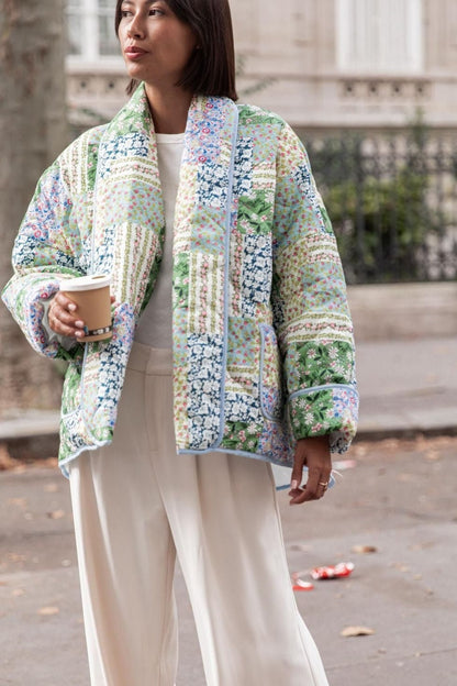 Multicolor - Women's relaxed-fit quilted jacket featuring a vibrant patchwork floral print in pastel greens and blues, styled open with contrast edge binding.
