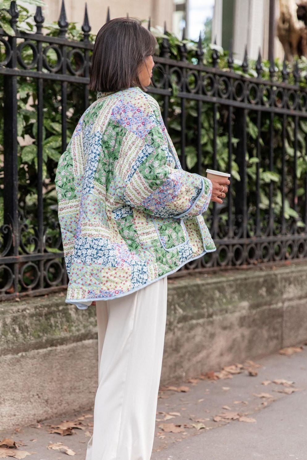 Multicolor - Women's relaxed-fit quilted jacket featuring a vibrant patchwork floral print in pastel greens and blues, styled open with contrast edge binding.