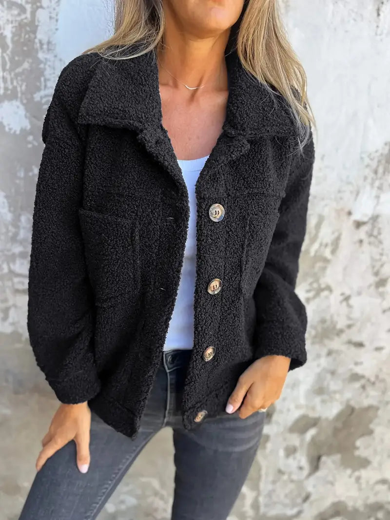 Black - A woman wearing a pink, textured teddy fleece shacket with large buttons and chest patch pockets, styled casually over a white top and dark jeans.