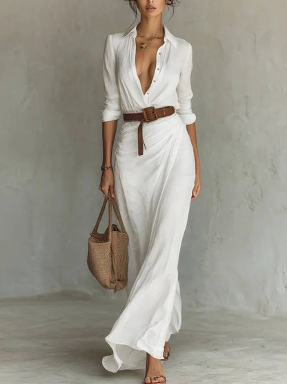White - A woman wearing a sand-coloured, textured crepe maxi shirt dress with a plunging collared neckline, ruched waist detailing, and a draped wrap-effect skirt.