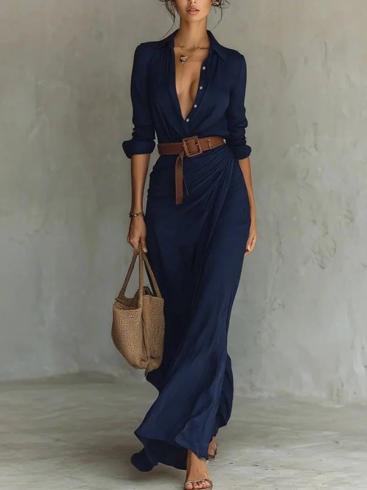 Blue - A woman wearing a sand-coloured, textured crepe maxi shirt dress with a plunging collared neckline, ruched waist detailing, and a draped wrap-effect skirt.