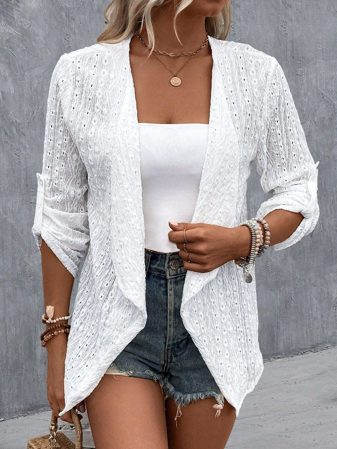 White - Women's white lightweight open-front cardigan featuring a textured eyelet pattern, draped lapels, and roll-tab sleeves, styled over a white top and denim shorts.