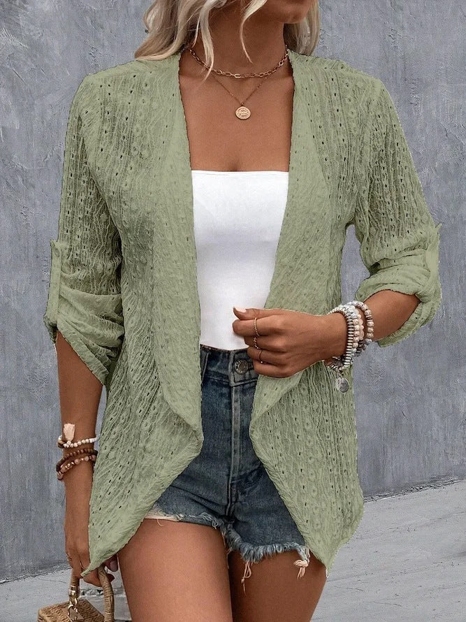 Green - Women's white lightweight open-front cardigan featuring a textured eyelet pattern, draped lapels, and roll-tab sleeves, styled over a white top and denim shorts.