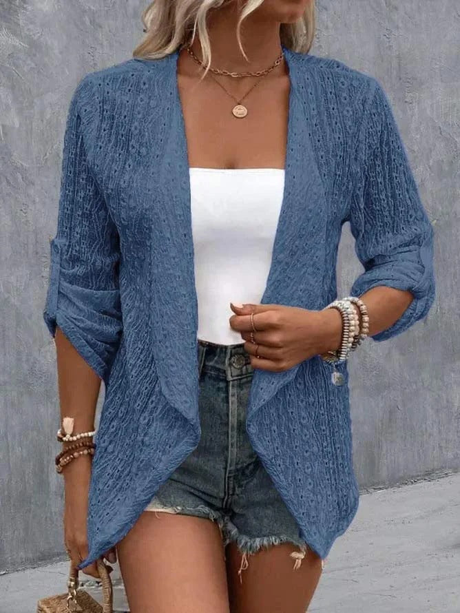 Blue - Women's white lightweight open-front cardigan featuring a textured eyelet pattern, draped lapels, and roll-tab sleeves, styled over a white top and denim shorts.