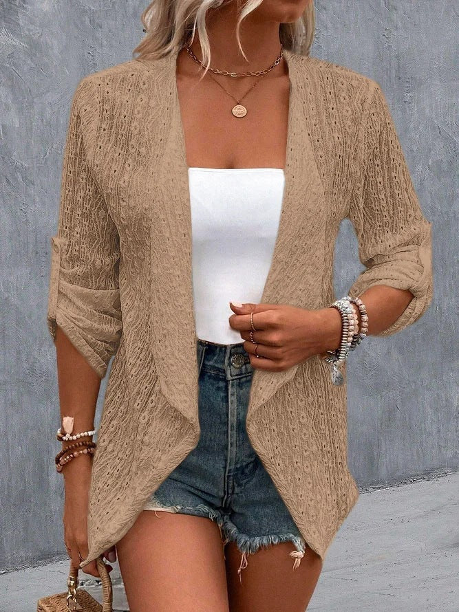 Khaki - Women's white lightweight open-front cardigan featuring a textured eyelet pattern, draped lapels, and roll-tab sleeves, styled over a white top and denim shorts.