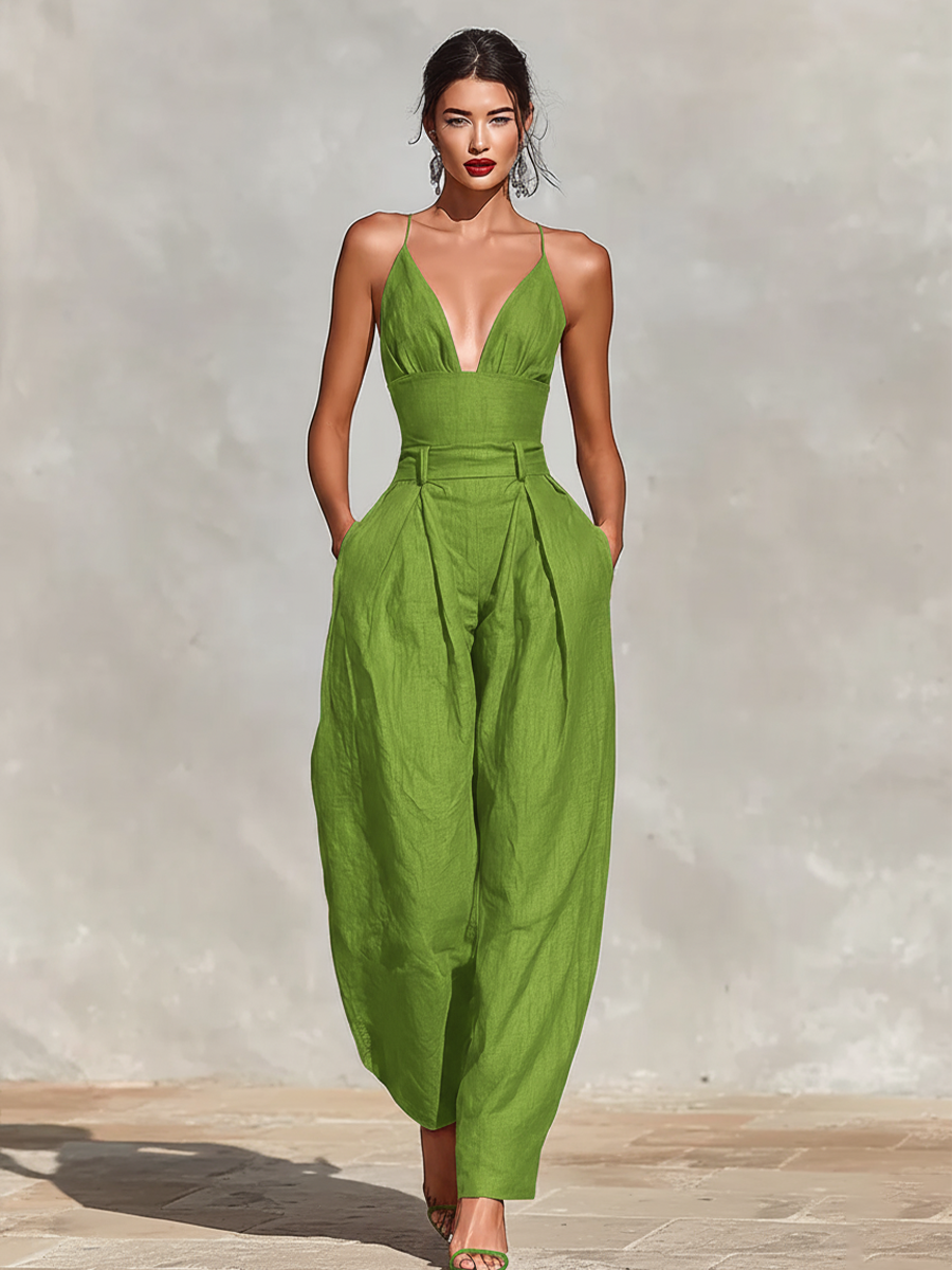 Green - A model wearing a deep red, textured linen wide-leg jumpsuit featuring a plunging V-neckline, structured high waist, and pleated trousers.