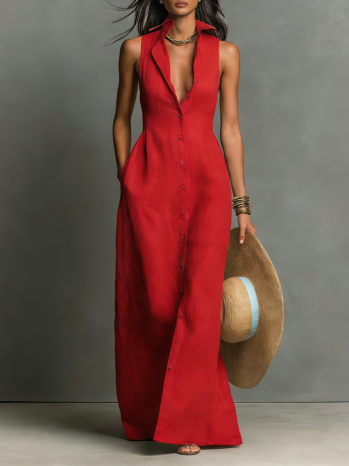 Red - A woman wearing a sleeveless red maxi dress with a point collar, button-down front, and side pockets, holding a wide-brimmed straw hat.