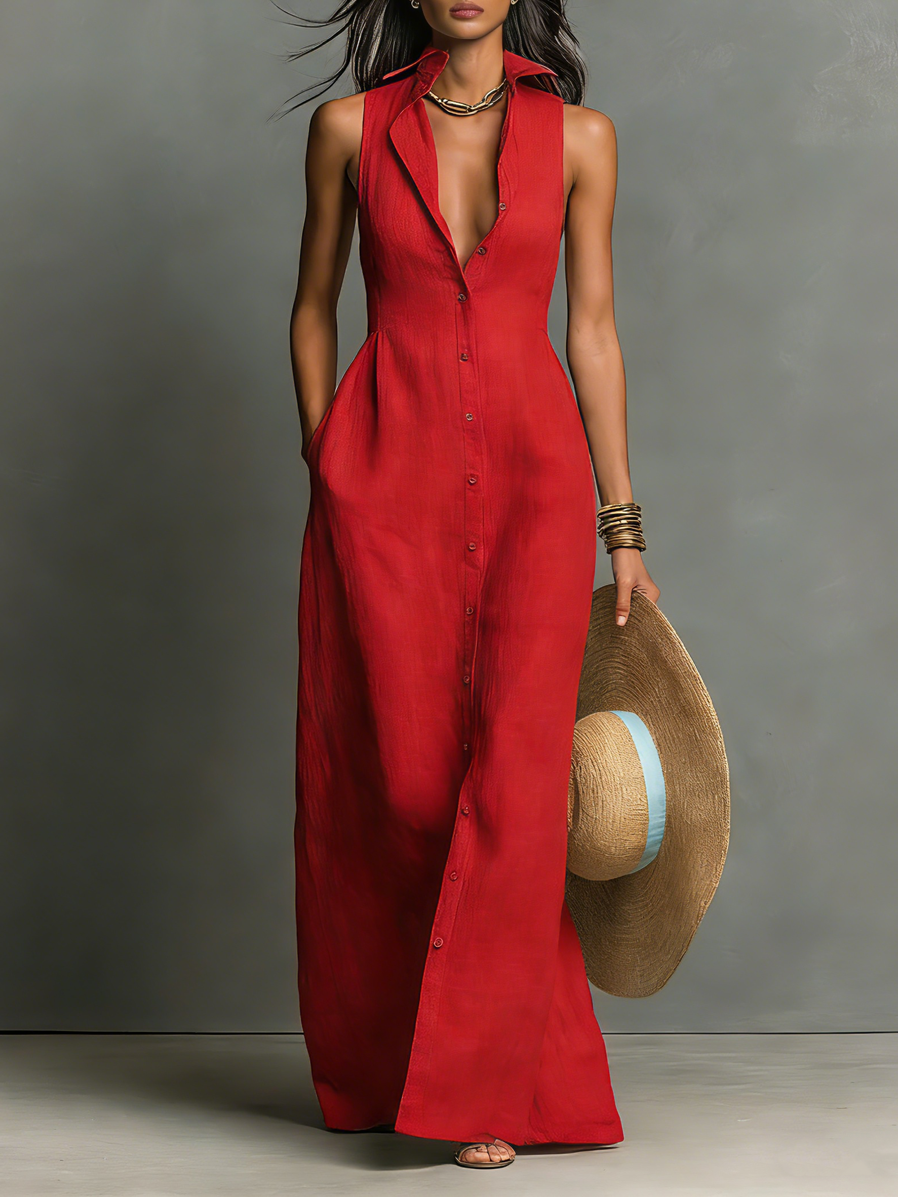 Red - A woman wearing a sleeveless red maxi dress with a point collar, button-down front, and side pockets, holding a wide-brimmed straw hat.