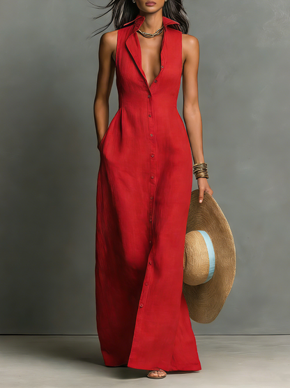 Red - A woman wearing a sleeveless red maxi dress with a point collar, button-down front, and side pockets, holding a wide-brimmed straw hat.