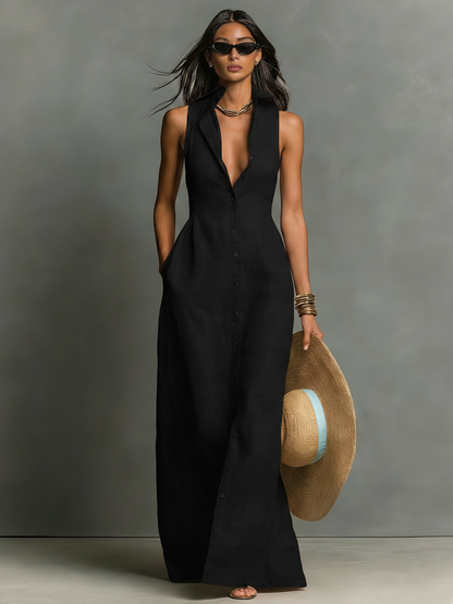 Black - A woman wearing a sleeveless red maxi dress with a point collar, button-down front, and side pockets, holding a wide-brimmed straw hat.