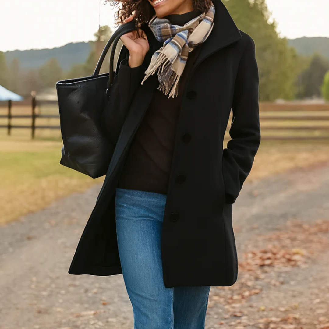 Black - A woman walking outdoors wearing a camel-coloured, mid-length textured coat with a stand collar and single-breasted button closure, styled with blue jeans and a scarf.