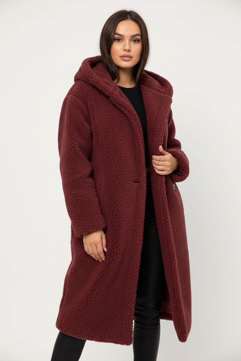 Red - A woman wearing a mid-length olive green textured teddy coat with a large hood, styled over a black turtleneck sweater and black sunglasses against a plain white background.