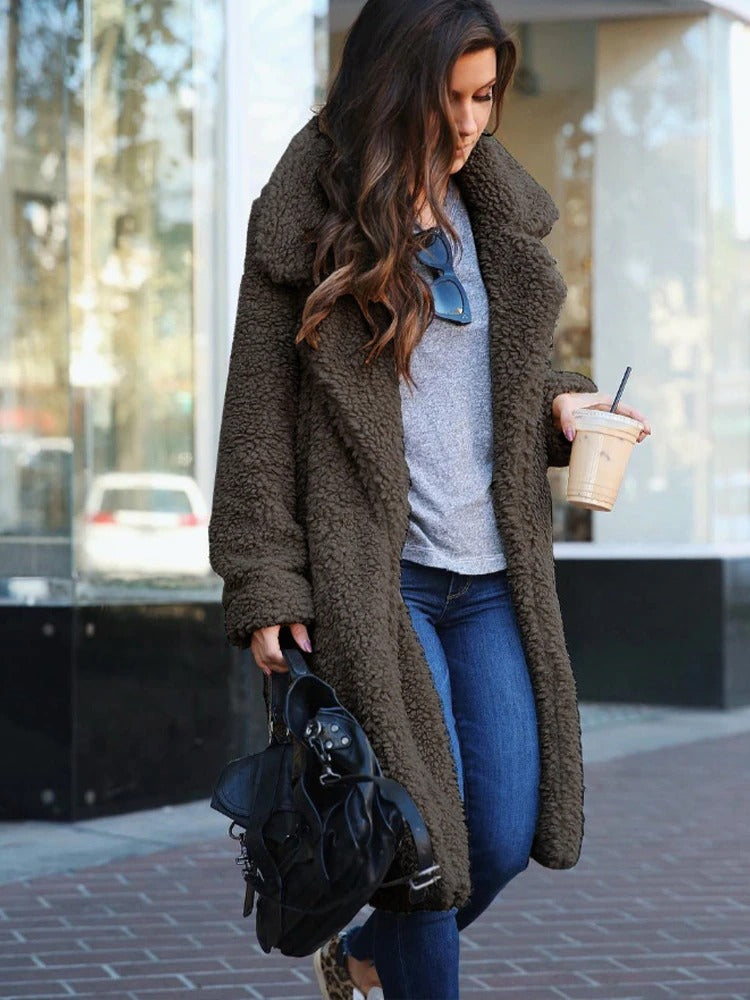 Dark Gray - A woman wearing a cream-coloured, longline textured teddy coat with oversized lapels, styled over a grey t-shirt and blue jeans.