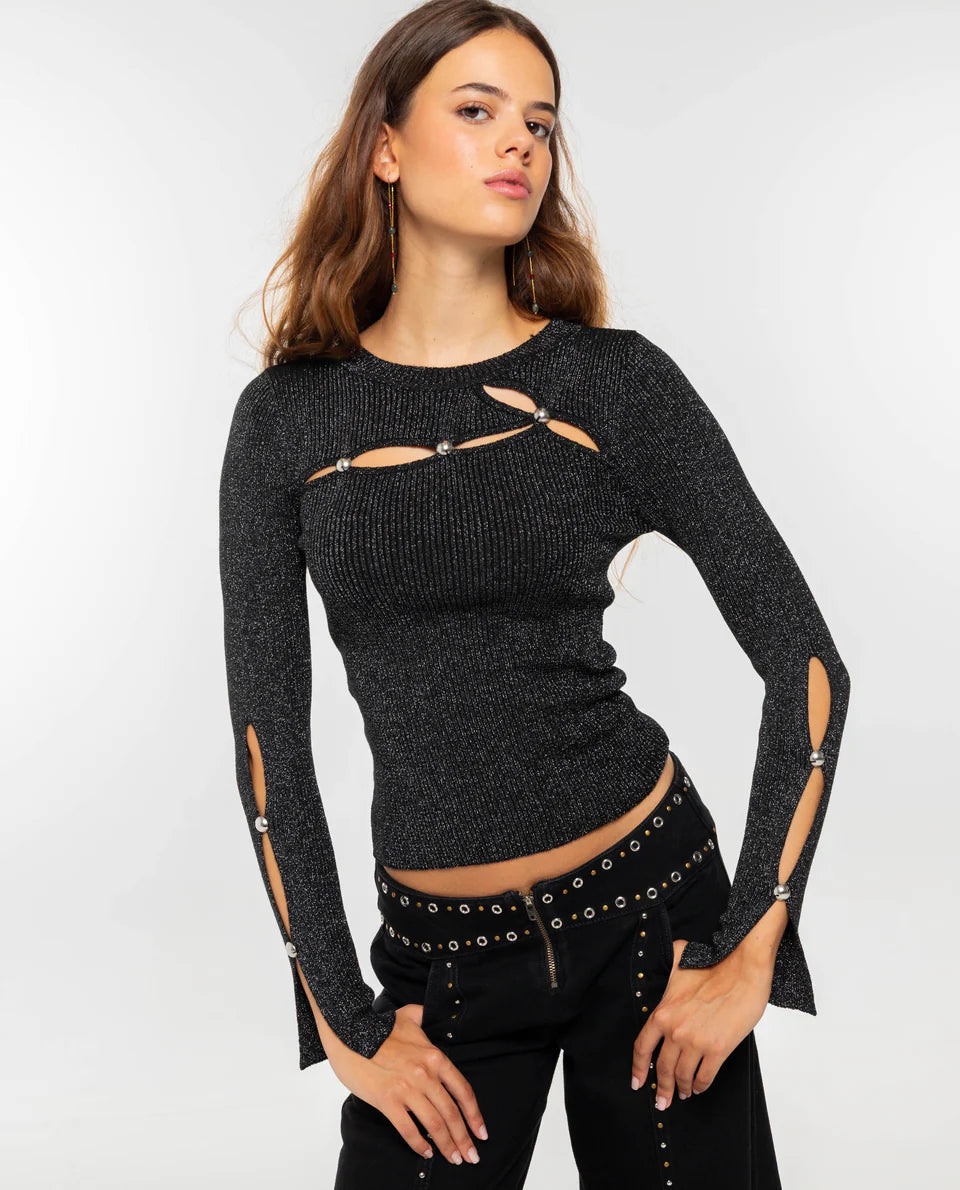 Women's dark burgundy ribbed knit long-sleeve top featuring cut-out details across the chest and forearms, held together by round metallic hardware.
