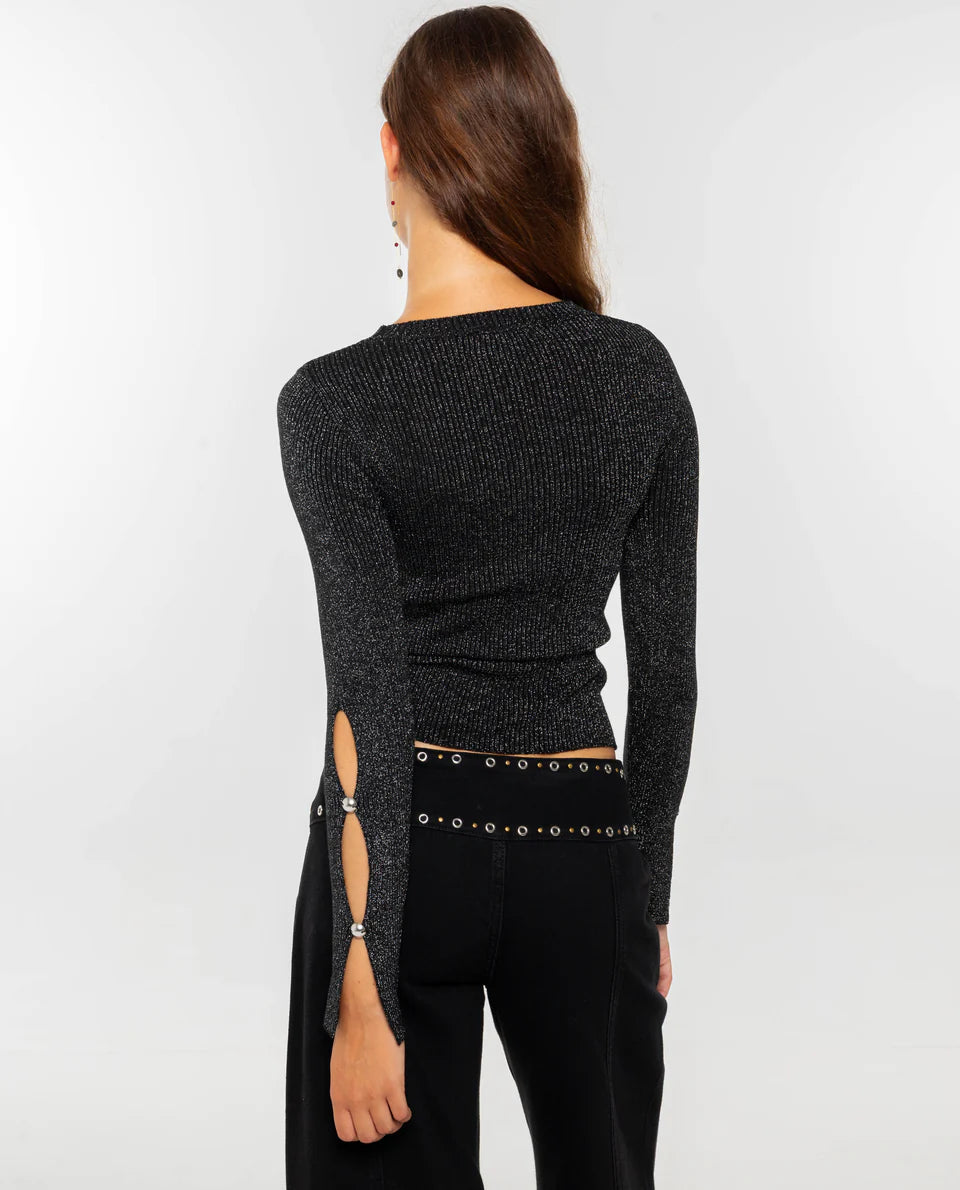 Women's dark burgundy ribbed knit long-sleeve top featuring cut-out details across the chest and forearms, held together by round metallic hardware.
