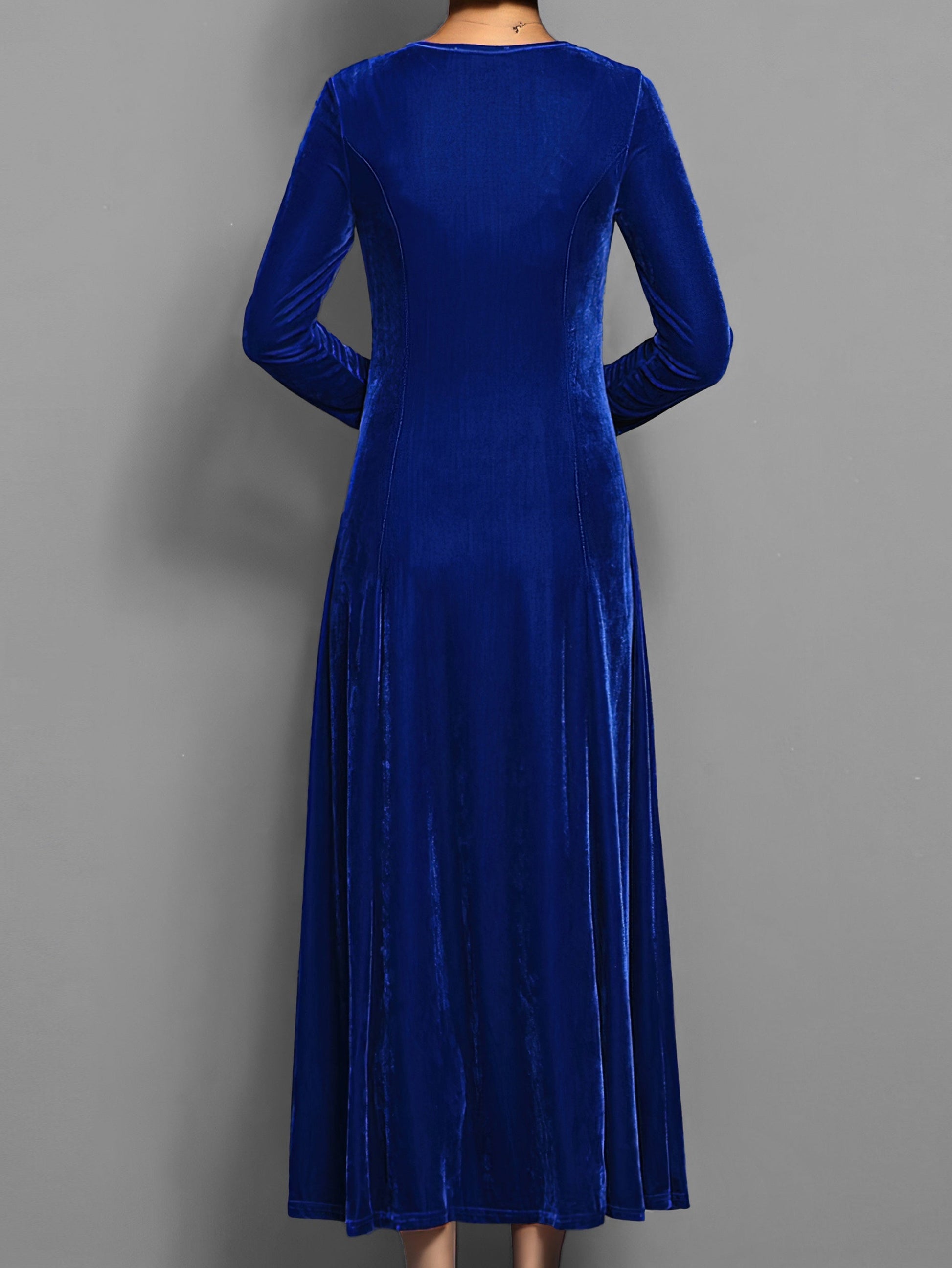 Blue - A woman wearing a long sleeve, A-line velvet maxi dress with vertical panelled seams.