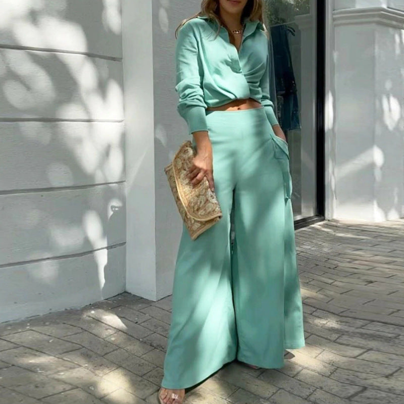 Emerald Green - Women's beige two-piece set featuring a long-sleeve collared crop top and high-waisted wide-leg pants with large cargo pockets, worn outdoors.